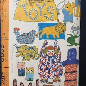 May include: A vintage sewing pattern for making various stuffed toys. The pattern includes instructions for making a clown, an elephant, an owl, a lion, a fish, a frog, a chicken, and a bag. The pattern is titled "Toys" and is from McCall's.