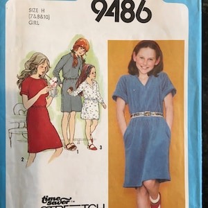 May include: Simplicity sewing pattern number 9486 for a girl's dress. The pattern is for sizes 7, 8, and 10. The pattern includes a time saver stretch knit option. The pattern shows a girl wearing a blue dress with pockets and a white belt.