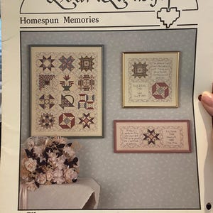May include: A cross-stitch pattern booklet titled "HeartStrings Homespun Memories" featuring a floral bouquet and three framed cross-stitch designs. The booklet is by Pat Thode, Designer and is part of The Artists Collection.