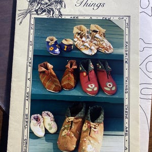 May include: A sewing pattern booklet titled Favorite Things 037 featuring illustrations of various fabric slippers. The cover displays multiple pairs of handmade booties in different patterns, colours, and textures, including plaid, floral, and solid fabrics.