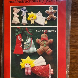 May include: A patchwork pattern and instructions for making tree ornaments. The pattern includes a girl, boy, flying angel, and gingerbread boy. The pattern is titled "Tree Trimmers 1" and is by Yours Truly Inc.