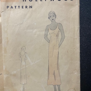 May include: Vintage sewing pattern for a dress, featuring a line drawing of a woman wearing a sleeveless dress. The pattern is labeled "HOLLYWOOD PATTERN" and has the number "526" with the measurements "36 Bust 39 Hip".