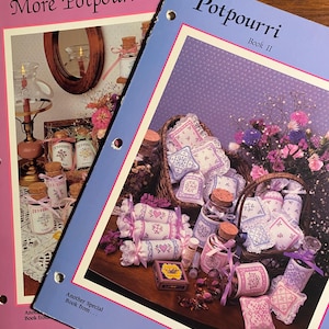 May include: Two books titled "More Potpourri" and "Potpourri Book II" with images of various craft projects, including sachets, pillows, and jars. The projects are decorated with lace and ribbons and feature floral designs.