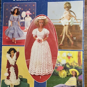 May include: A vintage crochet pattern booklet for making doll clothes. The cover features five different doll outfits, including a wedding dress, a ballerina outfit, a dress with a hat, a coat, and a casual outfit. The booklet is titled "Fashion Doll Clothes" and is from Leisure Arts.