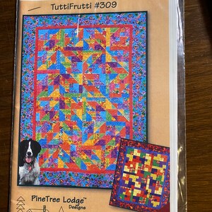 May include: A quilting pattern titled "Tutti Frutti #309" by PineTree Lodge Designs. The pattern features a colourful quilt with a geometric design and is labelled "Fat Quarter Friendly".