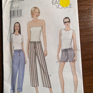 May include: A sewing pattern for women's clothing. The pattern includes three different styles: a pair of striped pants, a pair of denim pants, and a pair of shorts. The pattern is labeled "7591" and "Very Easy Vogue".
