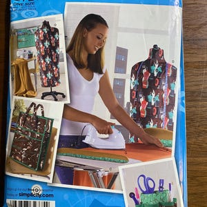 May include: A Simplicity sewing pattern package, featuring a woman ironing fabric. The package includes images of sewing projects, a dress form, and the text "Simplicity 2720" and "Project Runway."