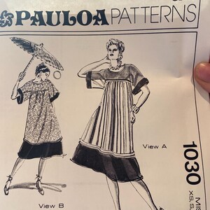 May include: A vintage sewing pattern from Paula Patterns, featuring two dress designs. The pattern number is 1030, with sizes XS to XL. The illustrations show dresses with short sleeves and contrasting trim, one with a floral print and the other with vertical stripes.