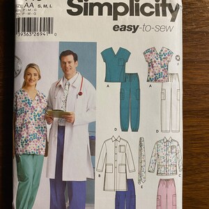 May include: Simplicity sewing pattern number 5443, easy-to-sew, for scrubs. The pattern includes a variety of styles, including a short-sleeved scrub top, long-sleeved scrub top, pants, and a lab coat. The pattern is shown on two models, one male and one female.