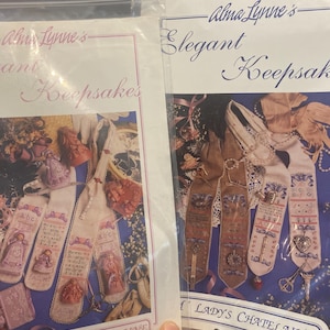 May include: A white ceramic mug with a black handle and the text "But First, Coffee" in a bold, black font. The mug is filled with a dark liquid, likely coffee, and sits on a light-colored surface.