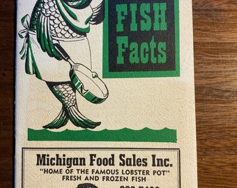 May include: A green and black illustration of a fish wearing a chef's hat holding a sign that says "FISH Facts". The text below the illustration reads "Michigan Food Sales Inc. "Home of the Famous Lobster Pot" Fresh and Frozen Fish 882-7400 or 882-7779 16901 Harper Detroit, Mich."