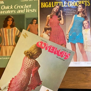 May include: Three vintage crochet pattern books with colorful covers. The first book is green and features a woman wearing a striped crochet top. The second book is pink and features a woman wearing a pink crochet dress. The third book is blue and features a woman wearing a blue crochet dress.
