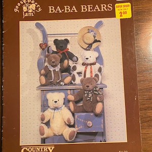 May include: A cross-stitch pattern for making five teddy bears. The pattern is called "Baba Bears" and is from Gooseberry Jam. The bears are sitting on a blue painted wooden bench with a drawer. The pattern is $4.00.