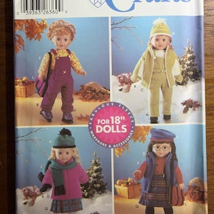May include: A Simplicity Crafts sewing pattern envelope for 18-inch doll clothing. The front displays four dolls wearing various outfits including overalls, jackets, hats, scarves, and skirts. The text reads 5676, Simplicity Crafts, and Fabulous Fleece for 18 inch dolls.