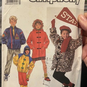 May include: Simplicity sewing pattern featuring children's outerwear designs. The pattern includes illustrations of coats, jackets, and a hooded outfit. The cover displays the pattern number 9871 and size A (SM-LG).