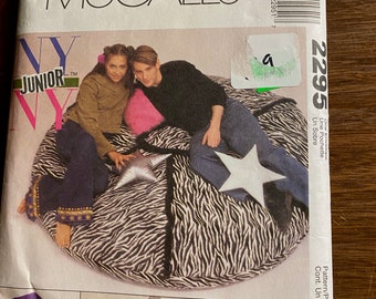 May include: A McCall's sewing pattern for a beanbag chair with a zebra print. The pattern is for a junior size and includes instructions for making a beanbag chair with a star design. The pattern is $10.95.