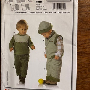 May include: A sewing pattern for a child's outfit. The pattern includes instructions for a waistcoat, a long-sleeved shirt, and trousers. The pattern is for sizes 6 months to 3 years. The pattern is from Burda style magazine and the pattern number is 9631.