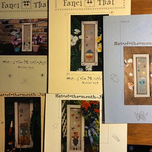 Hoed van de maand Kies ontwerp Kruissteekschema 1997 Getelde draadsteek - Elke maand een ander ontwerp - Fancy That - Hond Schaap Eend enz.
