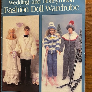 May include: A blue leaflet titled "Wedding and Honeymoon Fashion Doll Wardrobe" featuring images of dolls in knitted wedding and winter outfits. The leaflet includes the text "21 Knit Designs by Bonita McDonald."
