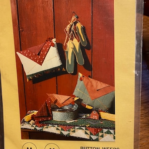 May include: Image of a craft project featuring a table runner, pot holder, and envelope pillow. The items are displayed against a red wooden background. The pot holder and pillow have a chicken theme. The text "THE LITTLE RHODE ISLAND RED HEN" is visible.