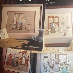May include: Several framed cross-stitch patterns featuring vintage scenes with dresses, furniture, and windows. The top left frame reads "Long Ago" and the top right frame reads "t's Pretend". The artist's name, Paula Vaughan, is visible on the top right.
