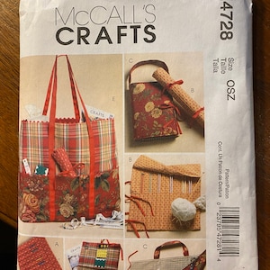 May include: A sewing pattern for a tote bag and various sewing accessories. The pattern includes instructions for making a tote bag with pockets, a needle roll, and a small zippered pouch. The pattern is printed on a white background with red and black text. The pattern number is M4728.