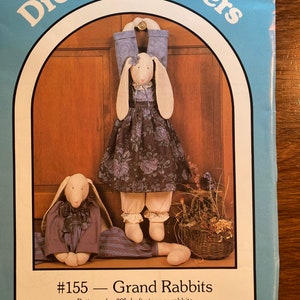 May include: A sewing pattern for two 30-inch draft stopper rabbits. The pattern is titled "#155 - Grand Rabbits" and is copyrighted by Nancy J. Smith and Lynda S. Milligan in 1988.