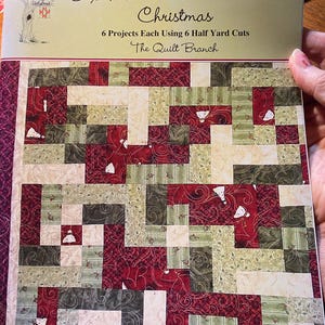 May include: A book titled "Six Halves Make a Whole Christmas" with a quilt pattern on the cover. The quilt pattern is made up of red, green, and white squares. The book is by The Quilt Branch and is number QB 142.