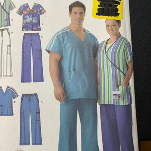 May include: A sewing pattern for scrubs with a blue and white striped top and blue pants. The pattern is for sizes small, medium, and large. The pattern is from Simplicity and is easy to sew.