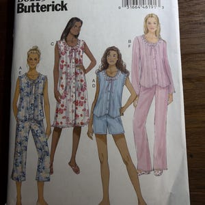 May include: A Butterick B6225 sewing pattern envelope for sleepwear, featuring illustrations of four variations: a floral print top with cropped pants, a floral nightgown, a blue top with shorts, and a solid pink long-sleeve top with long pants.