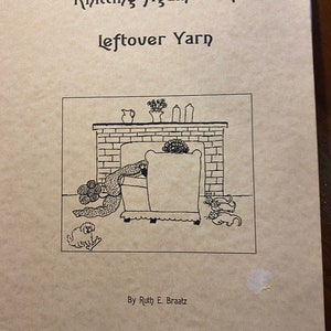 May include: A book cover with a black and white illustration of a person sitting in a chair by a fireplace. The book title is "Knitting Again With Leftover Yarn" and the author is "By Ruth E. Braatz".