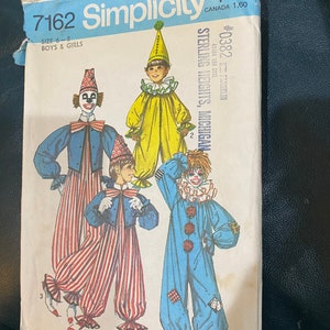 May include: A Simplicity sewing pattern for a clown costume. The pattern is for sizes 6-8 for boys and girls. The pattern shows three different clown costumes: one in yellow, one in blue, and one in red and white.