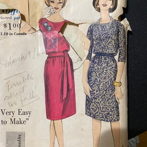 May include: Vintage sewing pattern for two dresses. The pattern is printed on paper and features illustrations of two women wearing the dresses. The text on the pattern reads "Vogue, printed pat, $100, 1.10 in Canada, March 9/62, Terrible skirt too full, Very Easy to Make", and "young fashionables".