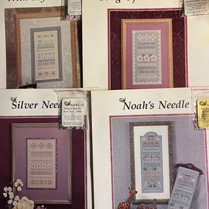 May include: Four framed needlepoint patterns with the titles "With My Need", "Song Of The Needle", "Silver Needle", and "Noah's Needle". Each pattern features intricate cross-stitch designs, floral motifs, and text. The patterns are displayed on a white background.