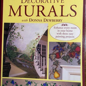 May include: A book titled "Decorative Murals" by Donna Dewberry. The cover features a yellow background with the title in large, bold letters. The book showcases mural painting projects, with images of painted walls and decorative floral borders.