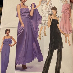 May include: Vogue pattern featuring several vintage dress designs. The designs include a long purple dress with ruffles, a white floral dress, a black top with pants, and a pink dress. The pattern number is 1896.