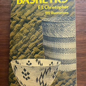 May include: A softcover book titled BASKETRY by F.J. Christopher with 155 Illustrations. The cover features a yellow title and text against a dark olive green background with images of a tall woven basket and a shallow woven bowl with black patterns.