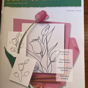 Puede incluir: Un libro titulado "How to Draw 1" de Walter T. Foster, con una tulipa rosa en la portada. El libro enseña técnicas de dibujo paso a paso, incluyendo la preparación para dibujar, el bloqueo de formas básicas, la creación de texturas simples y el sombreado inicial.