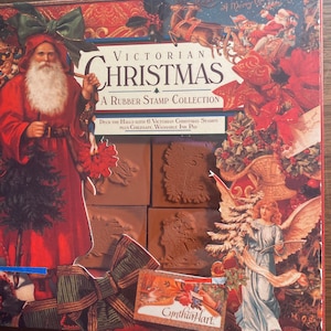 May include: A box of Victorian Christmas rubber stamps with a red, green and gold design. The box includes six stamps and a washable ink pad. The stamps feature images of angels, reindeer and other Christmas motifs. The box also includes the text "Victorian Christmas" and "A Rubber Stamp Collection".