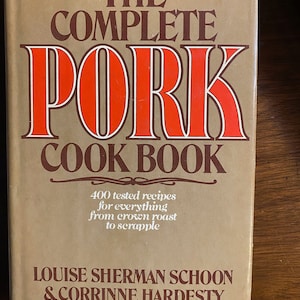 May include: The Complete Pork Cook Book, a brown cookbook with a red title and white text. The book features 400 tested recipes for everything from crown roast to scrapple. The authors are Louise Sherman Schoon and Corrine Hardesty.