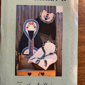 Puede incluir: Un patrón de costura para una sudadera con un diseño de corazón. El patrón se titula "Sweatjacket II" y es de "A Quilter's Wardrobe".