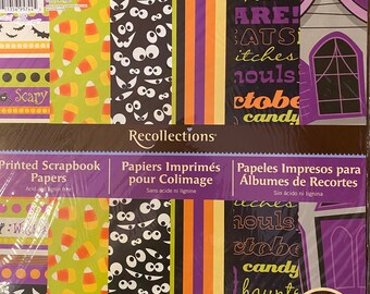 May include: A package of Recollections printed scrapbook papers with Halloween-themed designs. The designs include candy corn, spooky eyes, stripes, and a haunted house. The package contains 24 sheets, each measuring 12 inches by 12 inches.