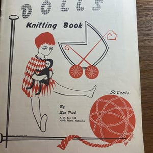 May include: A vintage softcover knitting book titled Dolls Knitting Book by Sue Peck. The cover features a red and white illustration of a person holding a doll, a baby carriage, and a ball of yarn with knitting needles. Text includes 50 Cents.