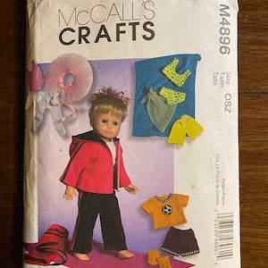 May include: A sewing pattern for making doll clothes. The pattern includes instructions for making a red jacket, black pants, a yellow shirt, a green skirt, a blue top, and a white tutu. The pattern is for size OSZ and is from McCall's Crafts.