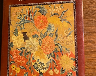 May include: A book titled "Needlepoint" by Hope Hanley. The cover features a colorful needlepoint design of a vase filled with flowers.
