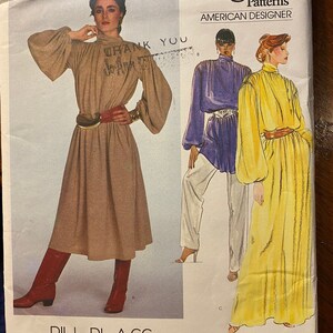 May include: Vogue Patterns American Designer sewing pattern by Bill Blass. The pattern features three different looks: a long-sleeved brown dress with a high neck, a long-sleeved purple dress with a high neck, and a long-sleeved yellow dress with a high neck. The pattern number is 2840.
