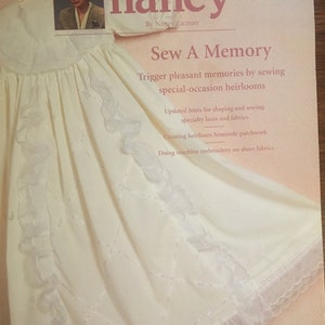 May include: A white sewing pattern book cover featuring a white dress on the front. The book title is "Sew A Memory" and the subtitle is "Trigger pleasant memories by sewing special-occasion heirlooms".