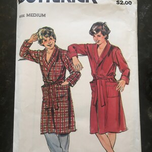 May include: A vintage sewing pattern for a robe, featuring two models wearing different styles. The pattern is from Butterick and is size medium. The pattern number is 3507 and the price is $2.00.
