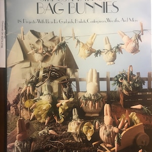 May include: A craft book cover with the title "Strings and Things IV Bag Bunnies" and a picture of 18 projects with ideas for garlands, baskets, centerpieces, wreaths, and more. The cover features a colorful illustration of various bunny-themed crafts.
