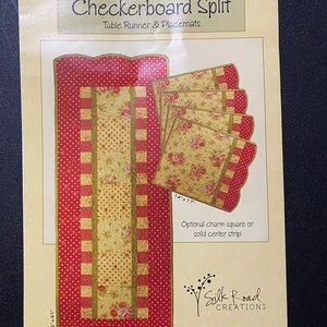May include: A sewing pattern for a checkerboard split table runner and placemats. The pattern includes instructions for a 15 1/2 inch by 41 inch table runner and 14 inch by 17 inch placemats. The pattern features a red and yellow checkered design with a floral print.